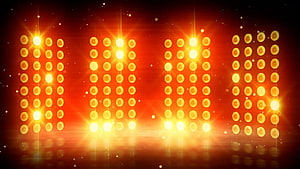 Vibrant Concert Stage Lighting with Glowing Amber LED Panels and Dramatic Lens Flares HD wallpaper
