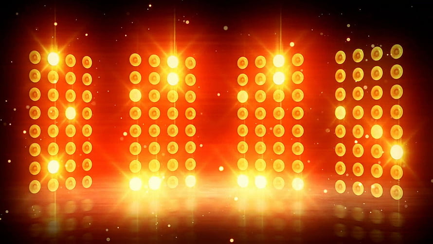 Vibrant Concert Stage Lighting with Glowing Amber LED Panels and Dramatic Lens Flares HD wallpaper