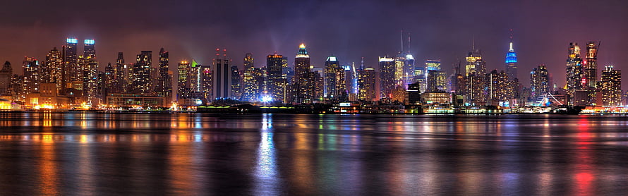 New York City Skyline at Night with Water Reflections and Illuminated Skyscrapers HD wallpaper