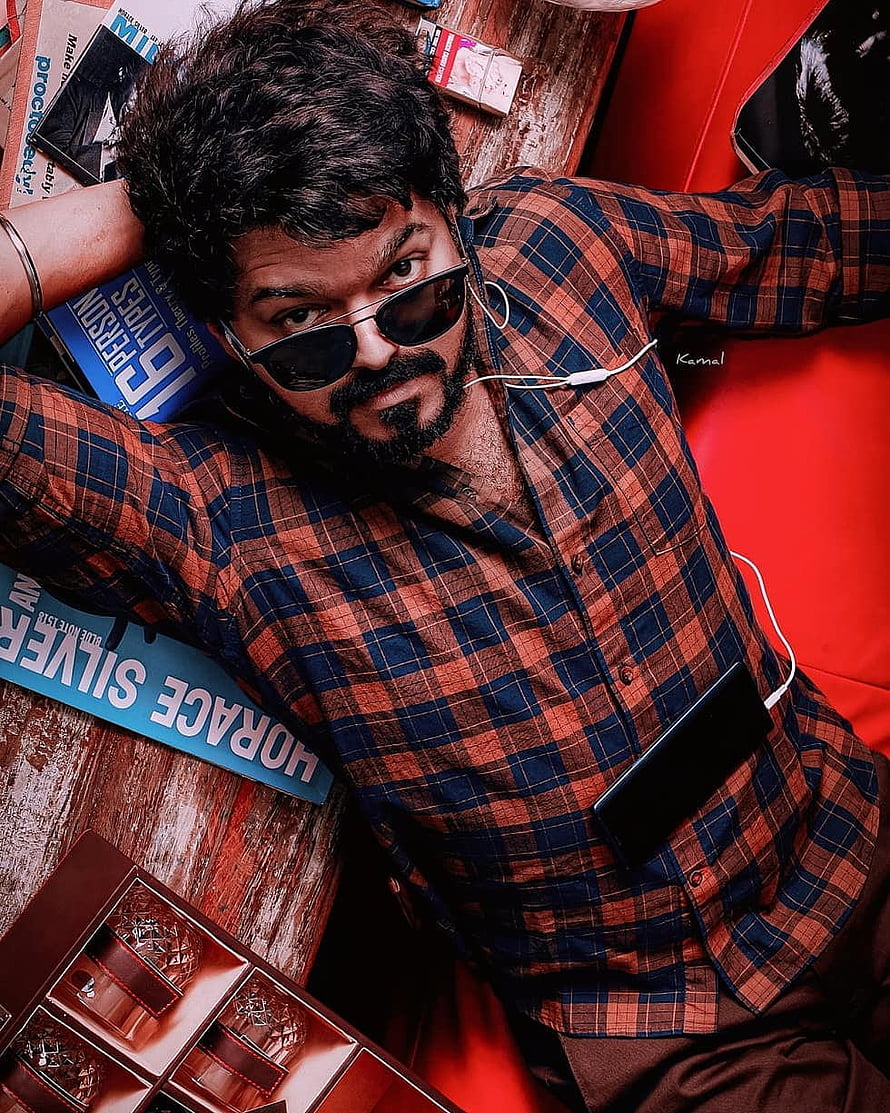 Vijay Sethupathi in a plaid shirt and sunglasses posing with a smartphone and books HD phone wallpaper