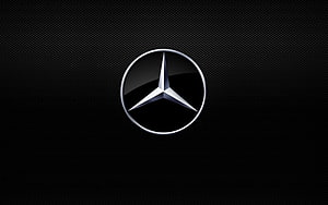 Mercedes-Benz Three-Pointed Star Emblem on Dark Carbon Fiber Texture HD wallpaper