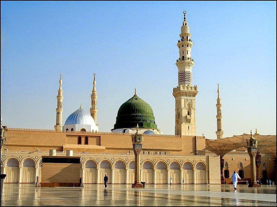 Al-Masjid an-Nabawi in Medina featuring the iconic Green Dome and towering minarets under a clear blue sky HD wallpaper