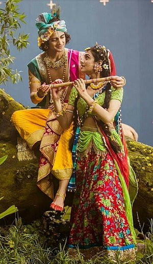 Radha Krishna Playing Flute in Vibrant Traditional Indian Attire HD phone wallpaper