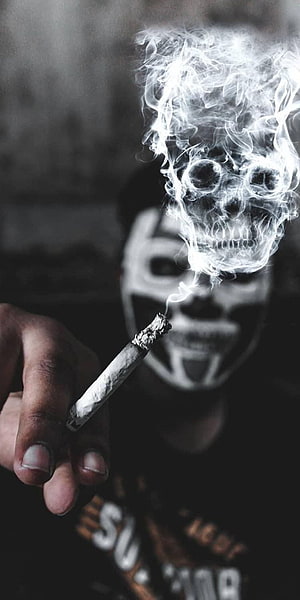 Joker Face Paint With Cigarette Smoke Forming A Skull In Black And White HD phone wallpaper