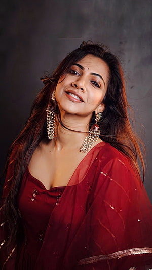 Madonna Sebastian in a deep red ethnic outfit with ornate gold jhumka earrings HD phone wallpaper