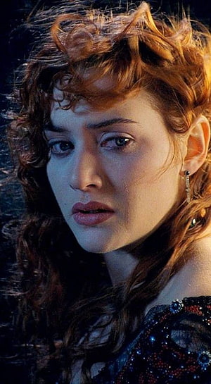 Kate Winslet in Titanic with curly auburn hair and dramatic cinematic lighting HD phone wallpaper