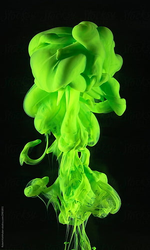 Vibrant Neon Green Ink Diffusing in Water Against a Black Background HD phone wallpaper