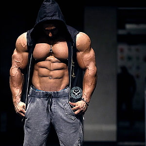 Muscular Bodybuilder in Black Hoodie Showing Defined Abs and Veiny Arms HD phone wallpaper