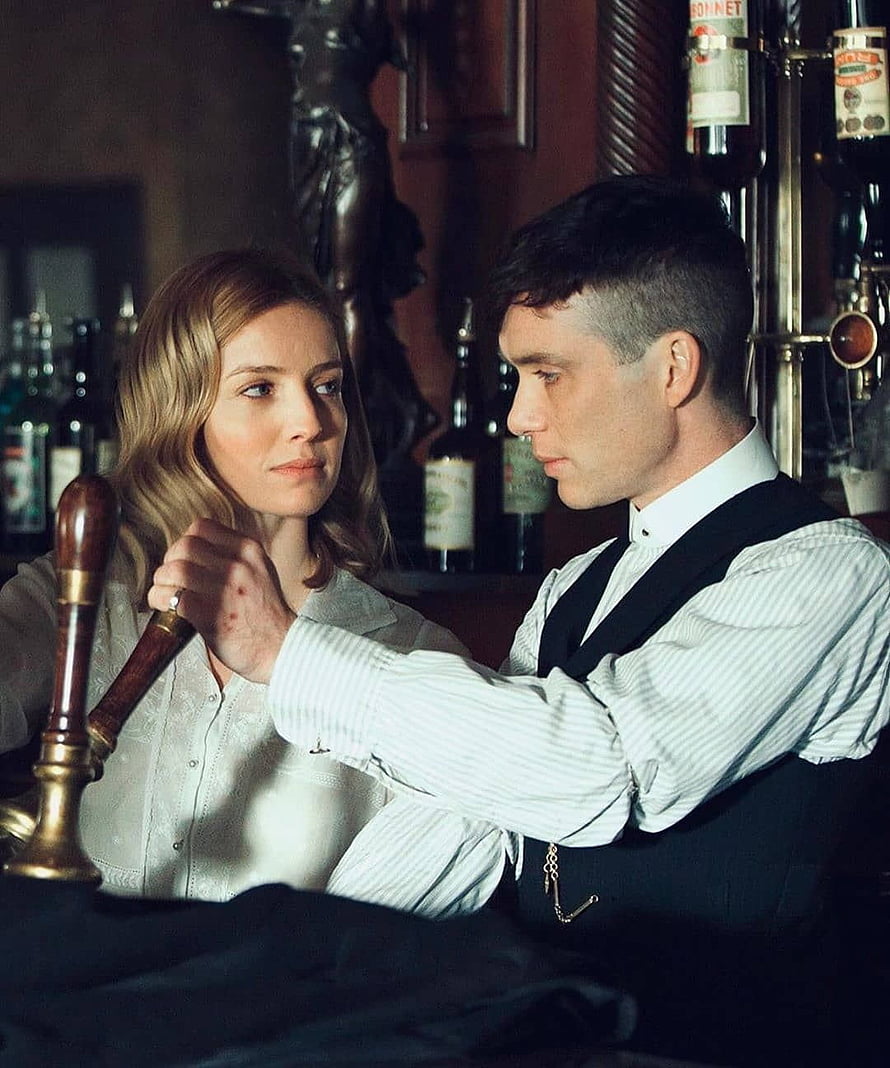 Tommy Shelby and Grace in a dimly lit bar scene from Peaky Blinders HD phone wallpaper