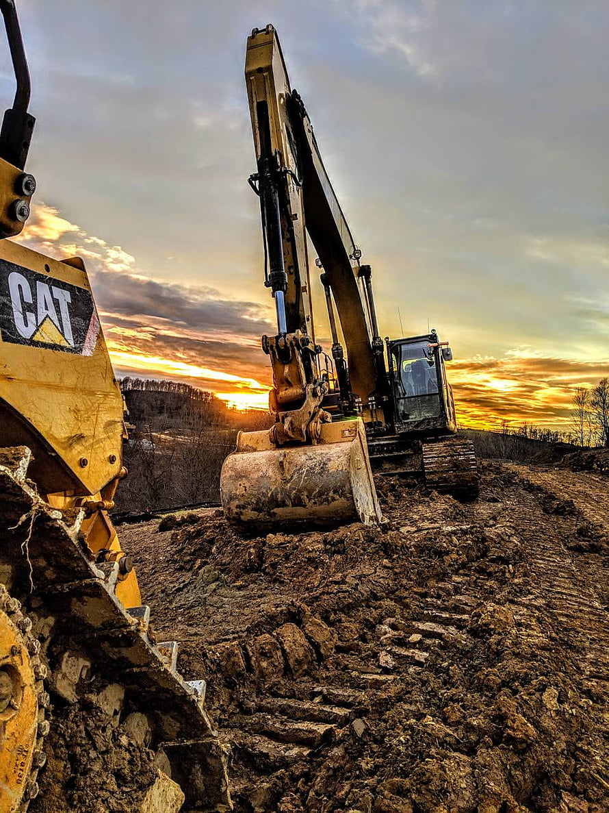 Caterpillar Excavator Digging at Sunset on a Construction Site HD phone wallpaper
