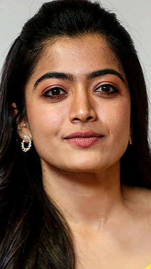 Portrait of Indian actress Rashmika Mandanna with dark hair and hoop earrings, Rashmika mandanna, telugu actress HD phone wallpaper