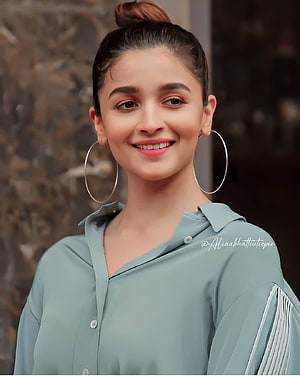 Alia Bhatt smiling portrait wearing a light blue shirt and large hoop earrings HD phone wallpaper
