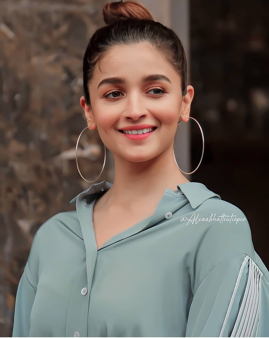Alia Bhatt smiling portrait wearing a light blue shirt and large hoop earrings HD phone wallpaper