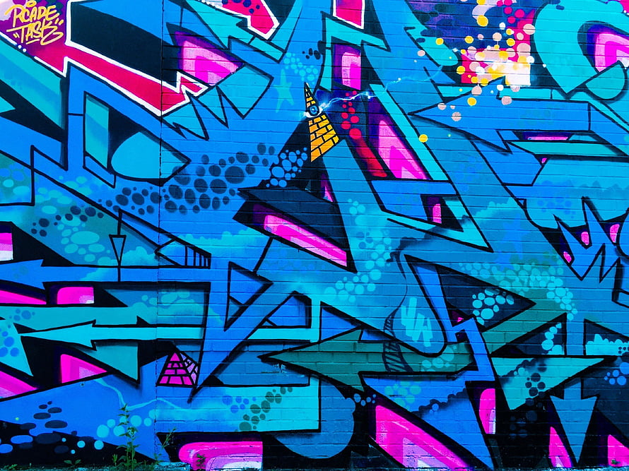 Vibrant Blue and Pink Graffiti Mural on Urban Brick Wall with Geometric Street Art Design HD wallpaper