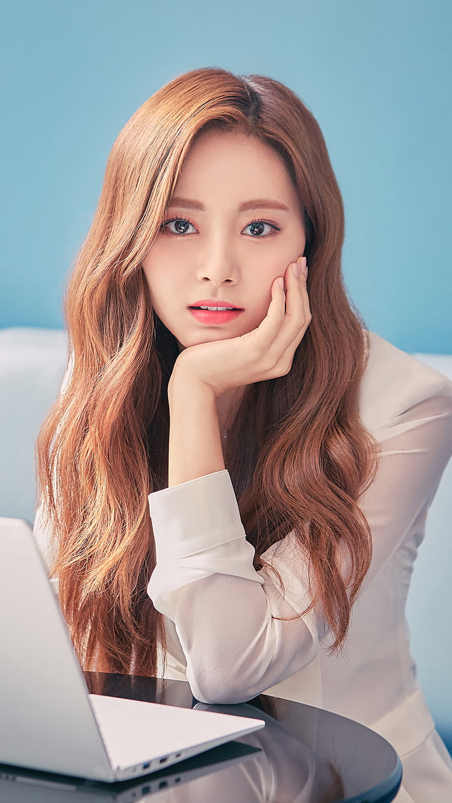 Tzuyu from TWICE in a white blazer resting her chin on her hand beside a laptop HD phone wallpaper