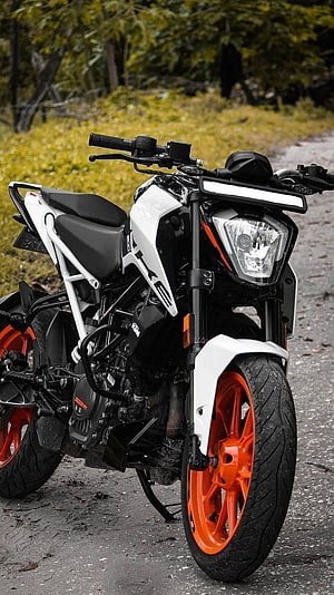 White KTM Duke 200 Motorcycle with Orange Rims Parked on Gravel Road HD phone wallpaper