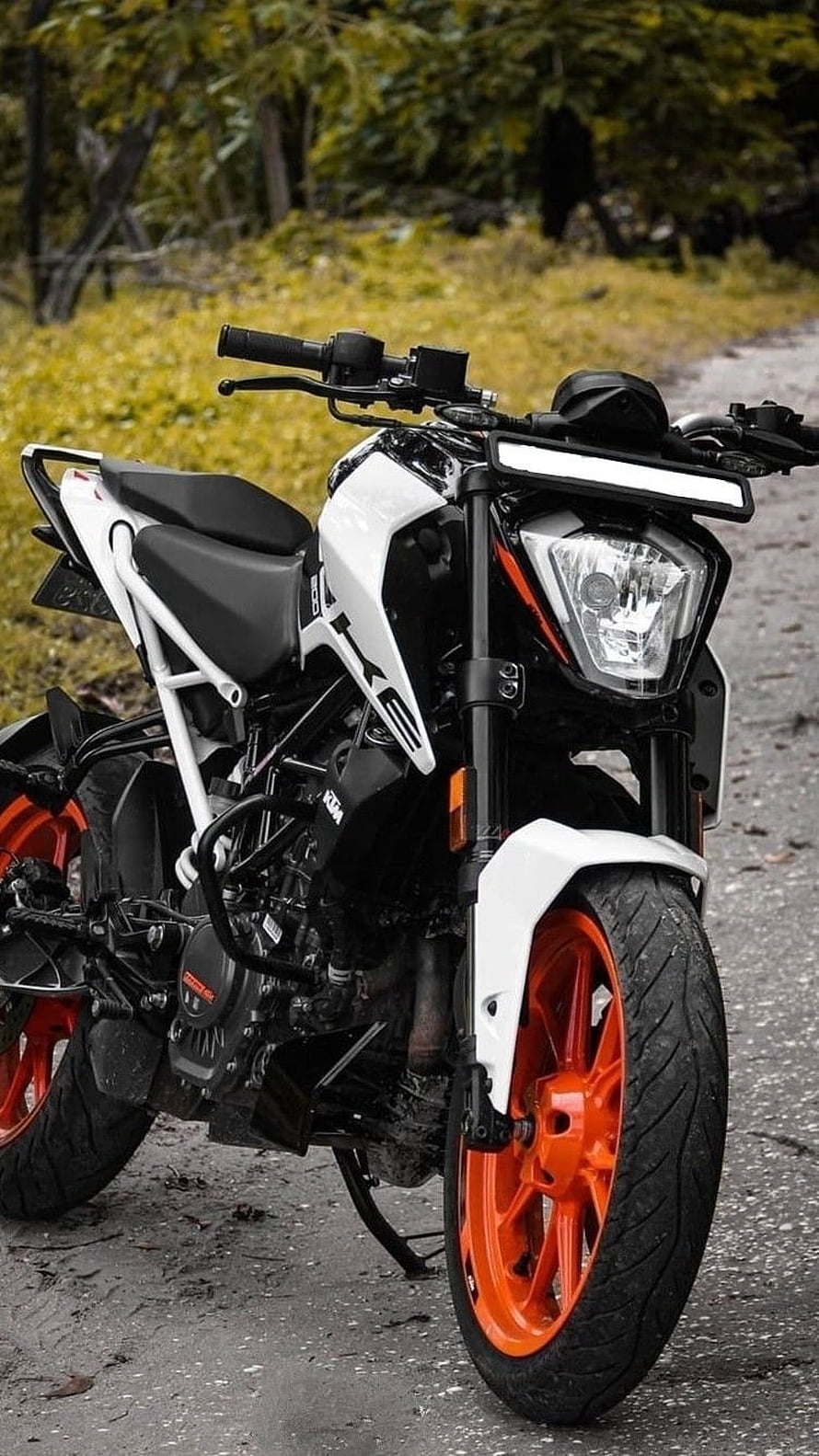 White KTM Duke 200 Motorcycle with Orange Rims Parked on Gravel Road HD phone wallpaper