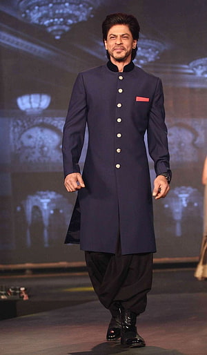 Shah Rukh Khan in a navy blue sherwani with black churidar on a fashion runway HD phone wallpaper