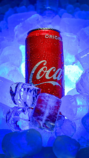 Chilled Coca-Cola Original Can Nestled in Glowing Blue Ice Cubes HD phone wallpaper