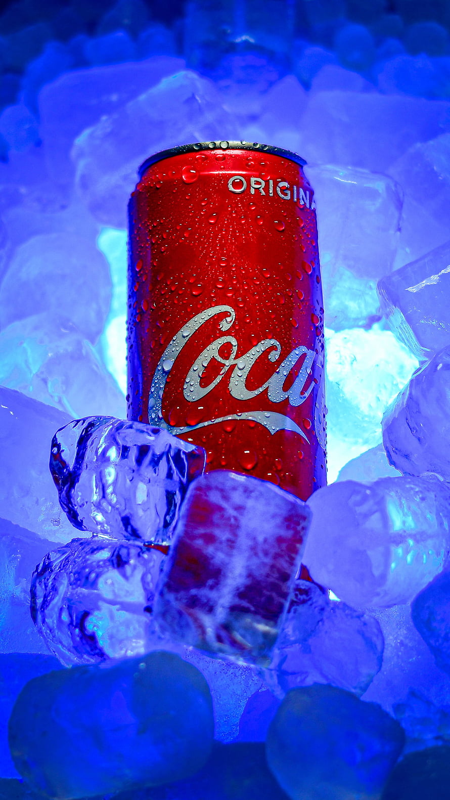 Chilled Coca-Cola Original Can Nestled in Glowing Blue Ice Cubes HD phone wallpaper