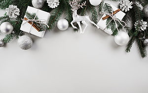 Elegant Christmas Border With Silver Ornaments, White Gifts, and Glittery Reindeer on White Background HD wallpaper