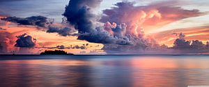 Dramatic Sunset Over Calm Ocean With Silhouette Island And Colorful Clouds HD wallpaper