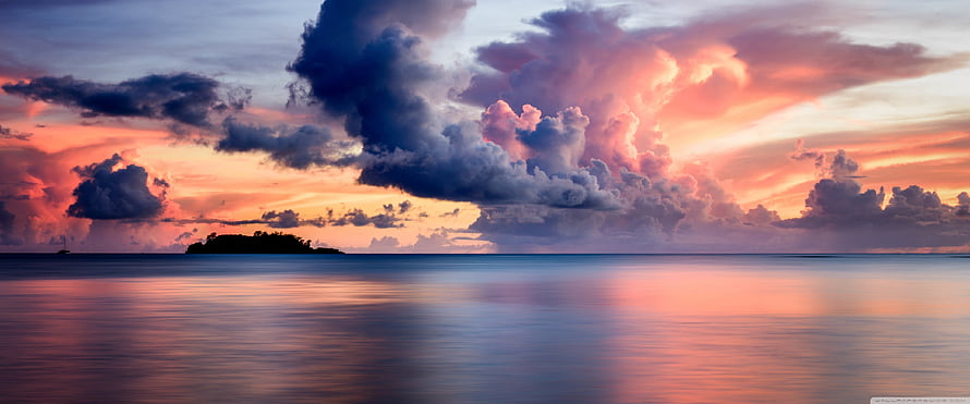 Dramatic Sunset Over Calm Ocean With Silhouette Island And Colorful Clouds HD wallpaper