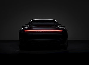 Porsche 911 Turbo S Rear View With Glowing Red Light Bar In Dark Studio Setting HD wallpaper