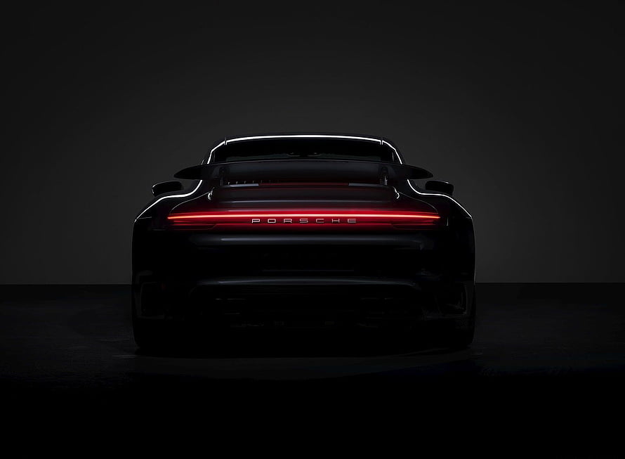 Porsche 911 Turbo S Rear View With Glowing Red Light Bar In Dark Studio Setting HD wallpaper