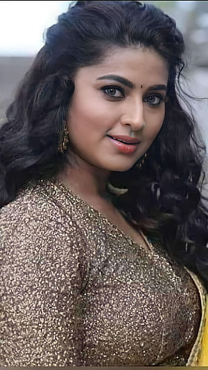 Portrait of Indian actress Rashmika Mandanna wearing a shimmering gold sequined dress with long wavy hair, Sneha, multilingual actress HD phone wallpaper