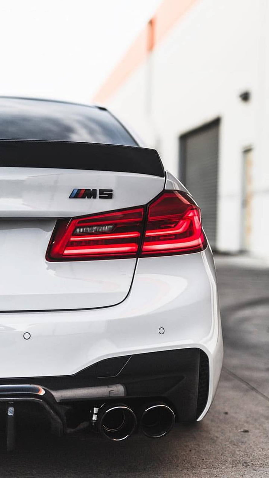 Rear View of White BMW M5 with Dual Exhaust and Sport Spoiler HD phone wallpaper