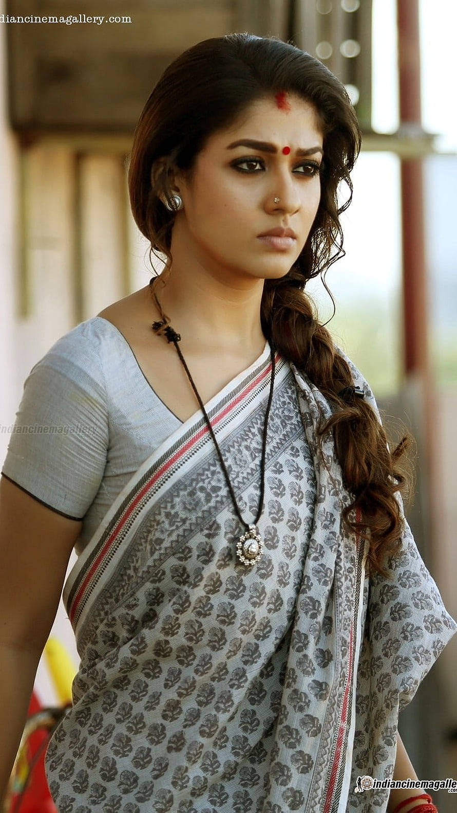 Nayanthara in a grey floral sari with a long pendant necklace and side braid HD phone wallpaper