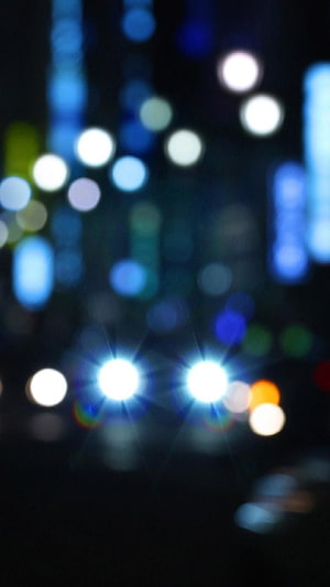 Abstract Night City Bokeh with Glowing Blue and White Light Orbs Against a Dark Background HD phone wallpaper