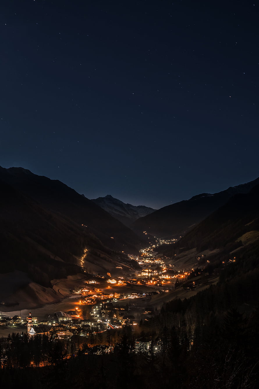 Night View of a Glowing Mountain Village Under a Starry Sky HD phone wallpaper