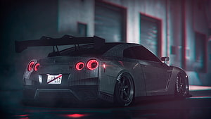 Nissan Skyline GT-R R34 Rear View with Large Wing in Dark Industrial Setting HD wallpaper