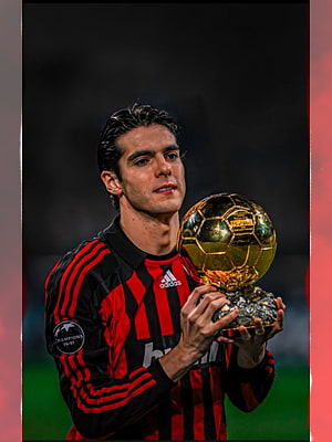Kaka in AC Milan kit holding the Ballon d'Or trophy on the pitch HD phone wallpaper