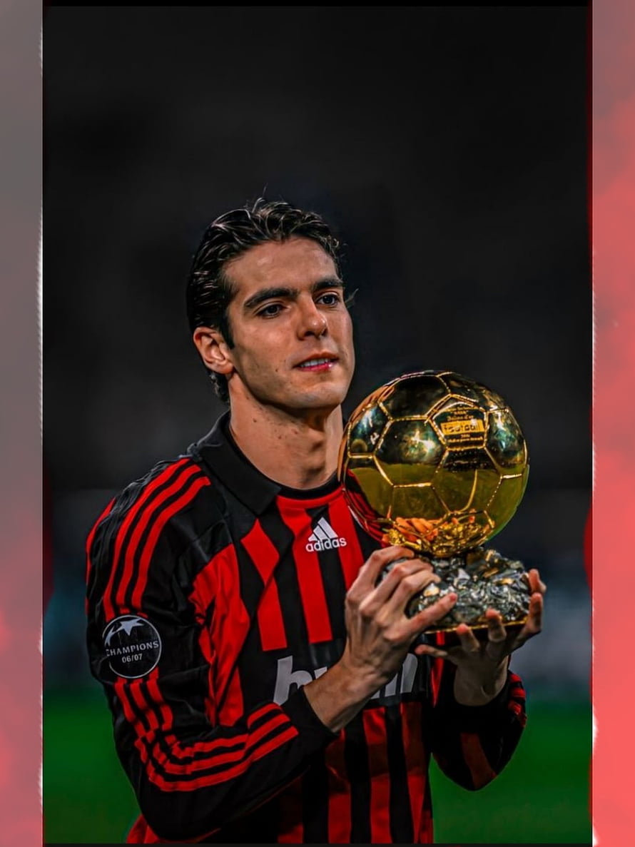 Kaka in AC Milan kit holding the Ballon d'Or trophy on the pitch HD phone wallpaper