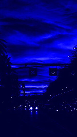 Moody Blue Tinted Highway at Night with Dramatic Clouds and Traffic Lights HD phone wallpaper