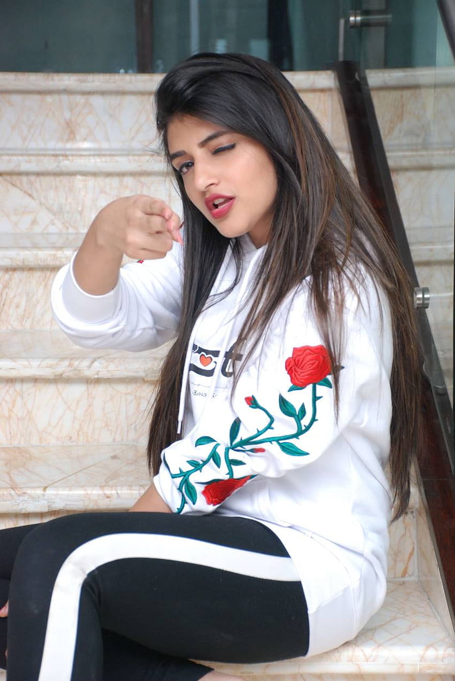 Sree Leela in White Rose Embroidered Hoodie Sitting on Marble Stairs HD phone wallpaper
