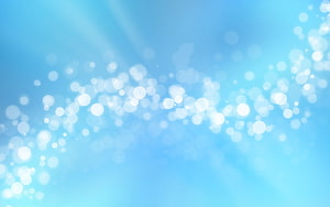 Soft Light Blue Bokeh Background with Floating White Light Particles and Gentle Rays HD wallpaper