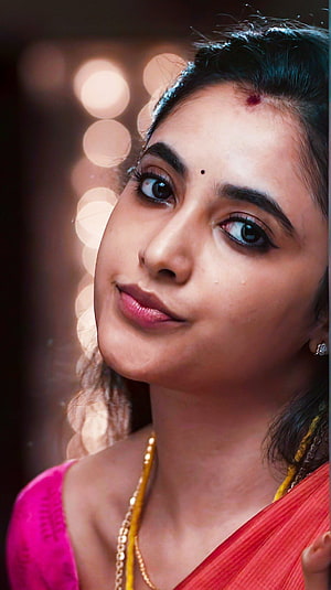 Pooja Hegde in a vibrant red saree with gold jewelry and bokeh background HD phone wallpaper