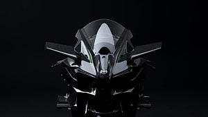 Front View of Sleek Black and White Sport Motorcycle with Aggressive Aerodynamic Fairing HD wallpaper