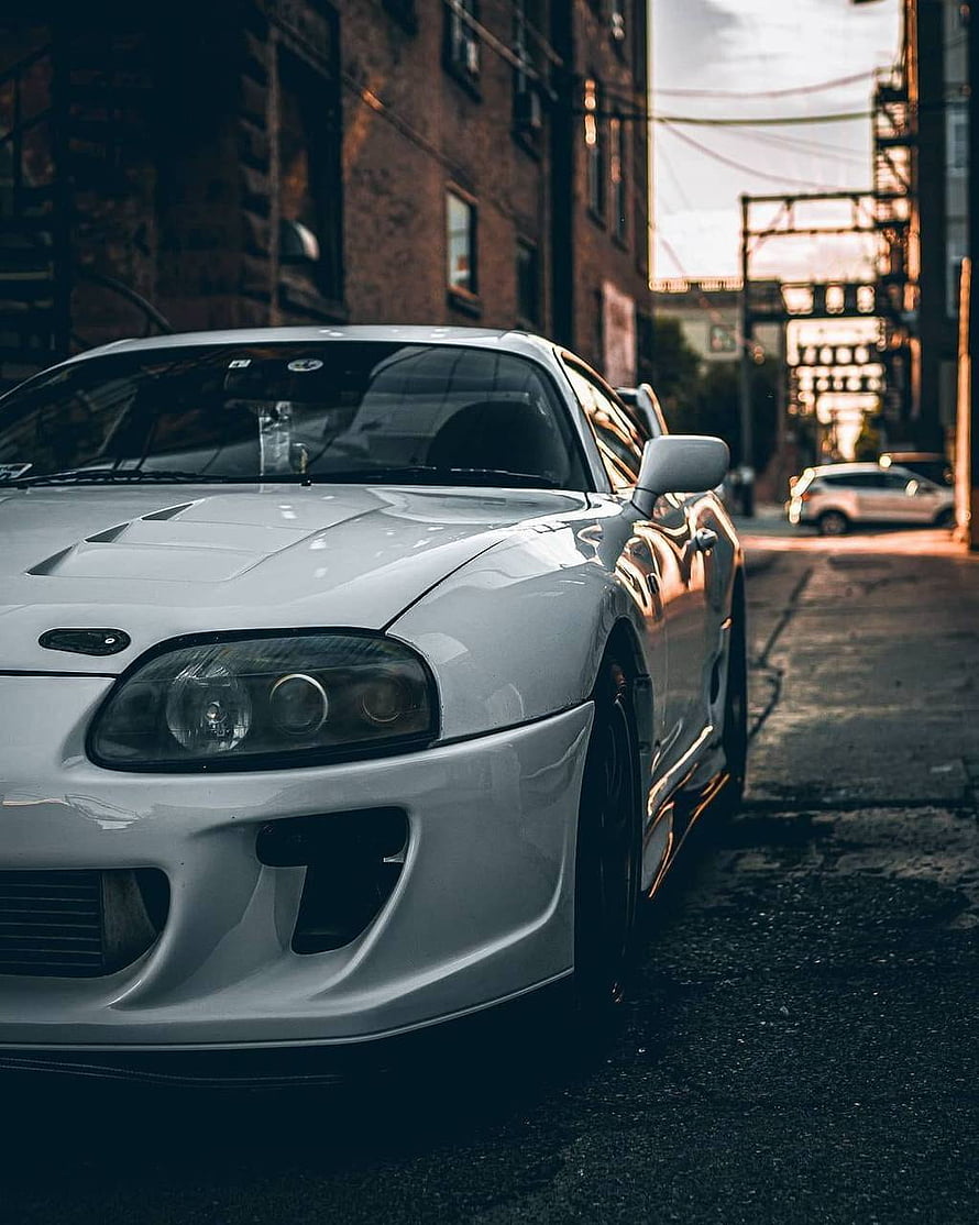 White Mitsubishi Lancer Evolution VII parked on urban street at sunset HD phone wallpaper