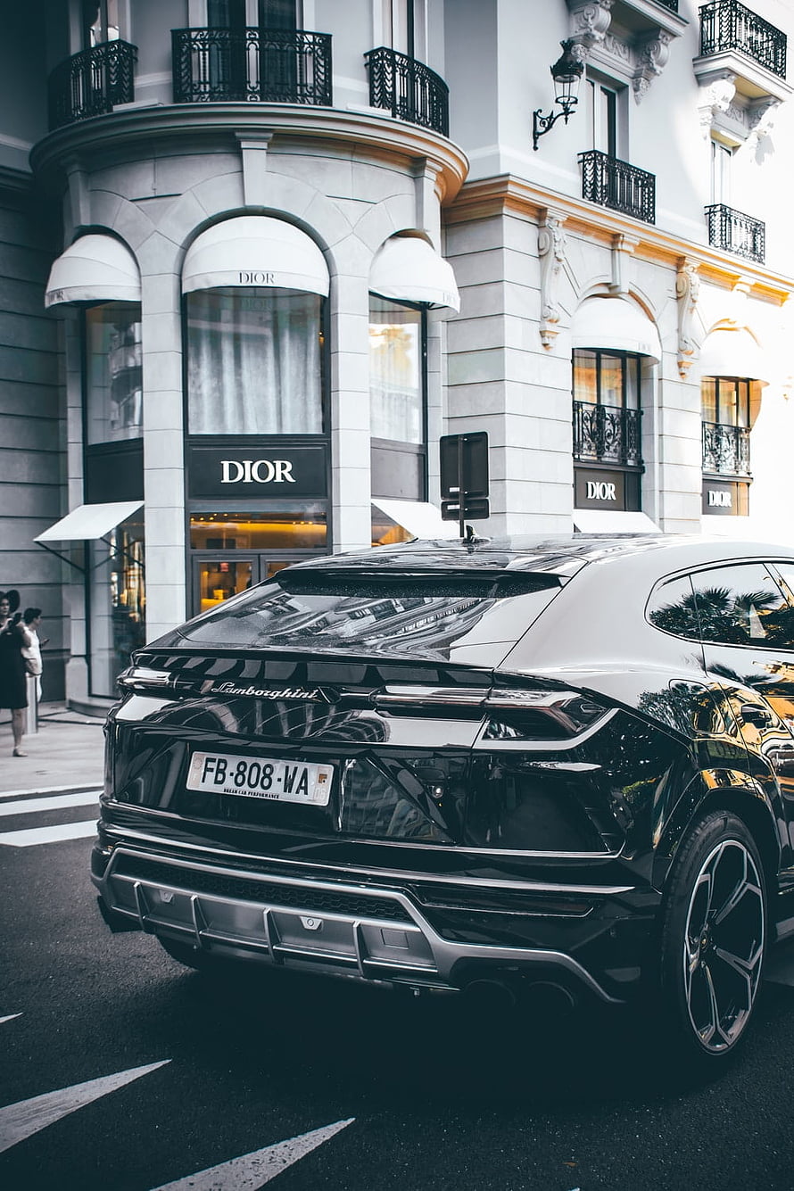 Black Lamborghini Urus Rear View Parked on Parisian Street in Front of Dior Boutique HD phone wallpaper