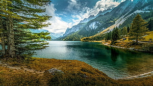 Serene Alpine Lake Surrounded by Majestic Mountains and Pine Forests HD wallpaper