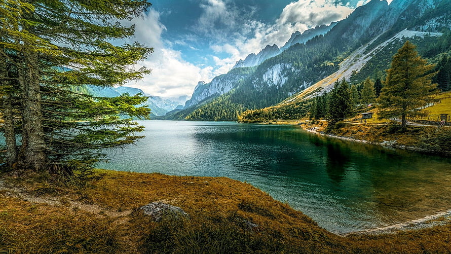 Serene Alpine Lake Surrounded by Majestic Mountains and Pine Forests HD wallpaper