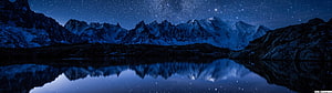 Starry Night Sky Over Snowy Mountain Range Reflected in Calm Lake HD wallpaper