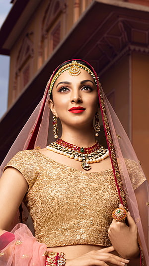 Kiara Advani in Traditional Indian Bridal Attire with Gold Jewelry and Pink Veil HD phone wallpaper