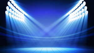 Blue Stage Spotlight Beams Illuminating an Empty Performance Venue with Dramatic Lighting HD wallpaper