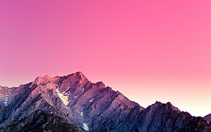 Majestic Mountain Peaks Under a Vibrant Pink Sunset Sky HD wallpaper